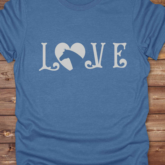 This Love Horses T-Shirt is the perfect expression of passion for horse lovers and cowgirls alike. With a unique heart-and-horse silhouette design and rustic western typography, it makes a thoughtful gift for birthdays, rodeo lovers, equestrians, and country women who live the cowboy lifestyle. The tee pairs well with denim, boots, and a bold cowgirl spirit. Whether for barn days, trail rides, or everyday western fashion, this shirt belongs in your rodeo ready wardrobe.