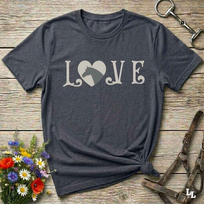 This Love Horses gray T-Shirt is the perfect expression of passion for horse lovers and cowgirls alike. With a unique heart-and-horse silhouette design and rustic western typography, it makes a thoughtful gift for birthdays, rodeo lovers, equestrians, and country women who live the cowboy lifestyle. The tee pairs well with denim, boots, and a bold cowgirl spirit. Whether for barn days, trail rides, or everyday western fashion, this shirt belongs in your rodeo ready wardrobe.