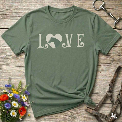 This Love Horses green T-Shirt is the perfect expression of passion for horse lovers and cowgirls alike. With a unique heart-and-horse silhouette design and rustic western typography, it makes a thoughtful gift for birthdays, rodeo lovers, equestrians, and country women who live the cowboy lifestyle. The tee pairs well with denim, boots, and a bold cowgirl spirit. Whether for barn days, trail rides, or everyday western fashion, this shirt belongs in your rodeo ready wardrobe.
