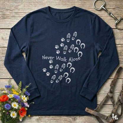 Navy blue long-sleeve shirt with shoe and paw print design on a wooden surface with flowers and equestrian equipment.