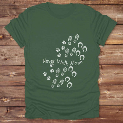 Celebrate the unbreakable bond between dogs, horses, and their human companions with this heartfelt "Never Walk Alone" western-style t-shirt. Featuring boot, paw, and hoof prints in a soft rustic print, this tee is perfect for cowgirls, dog moms, horse lovers, and equestrian trail riders alike. Whether you're walking through a ranch, riding across fields, or heading to the stables, this shirt is a perfect fit for your country lifestyle. Makes a thoughtful gift for birthdays, pet memorials, and western pet l