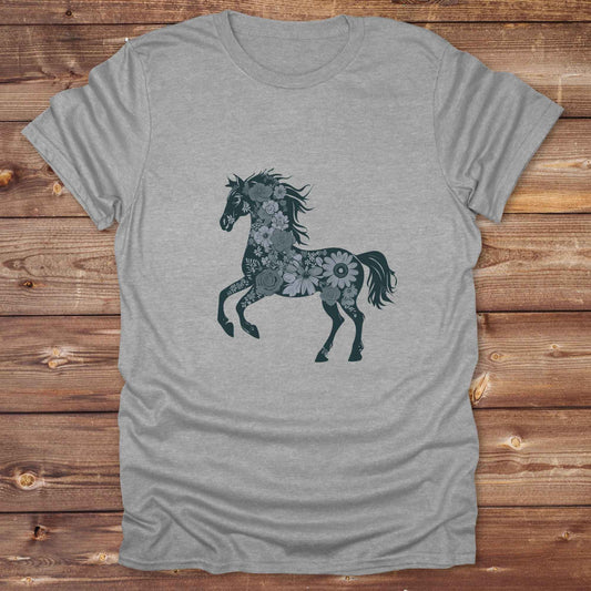 This Boho Flower Horse T-Shirt blends rustic western style with soft feminine charm, featuring a bold silhouette of a galloping mustang filled with intricate floral details. erfect for horse lovers, cowgirls, rodeo fans, and anyone who loves a touch of bohemian elegance in their western wardrobe. Made in 8 beautiful earthy tones, this graphic tee is ideal for birthdays, rodeo days, horse barn adventures, or simply showing off your equestrian spirit in everyday style.  