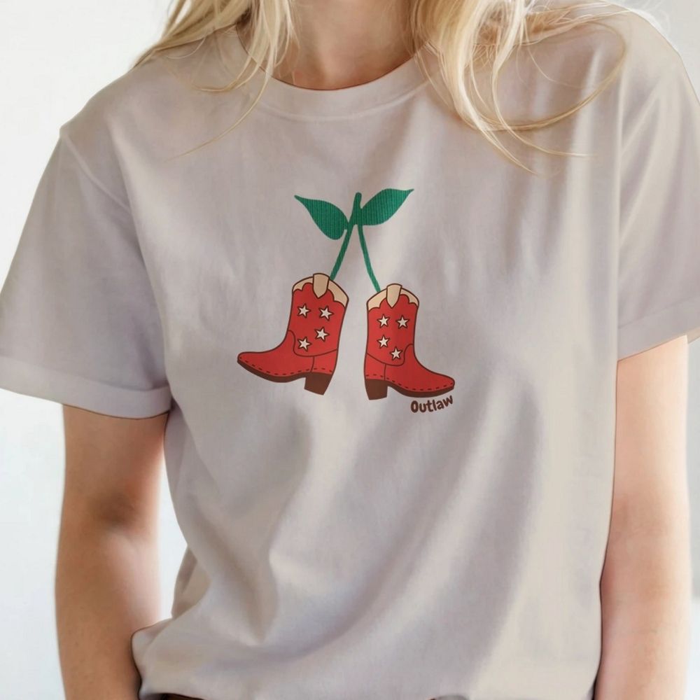 Model wearing beige Cherry Cowboy Boots T-Shirt for Horse Lovers, Equestrian Wear, Perfect gift for Horse Riders, horse girl shirt, horse mom shirt, horse lover, horse girl, Funny horse lover gifts, Funny horse shirts, Horse girl gifts, Equestrian graphic tees, fathers day gift, Sarcastic horse shirt