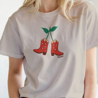 Model wearing beige Cherry Cowboy Boots T-Shirt for Horse Lovers, Equestrian Wear, Perfect gift for Horse Riders, horse girl shirt, horse mom shirt, horse lover, horse girl, Funny horse lover gifts, Funny horse shirts, Horse girl gifts, Equestrian graphic tees, fathers day gift, Sarcastic horse shirt