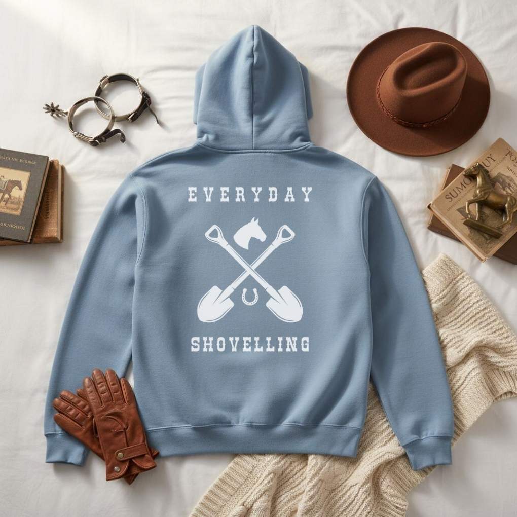Blue hoodie with 'Everyday Shovelling' text and shovel graphics on a white surface with accessories.