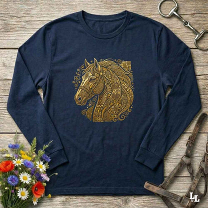 A navy blue long-sleeve t-shirt with a detailed gold horse head graphic on the chest, styled in a flat-lay on a rustic wooden background with equestrian and floral props.